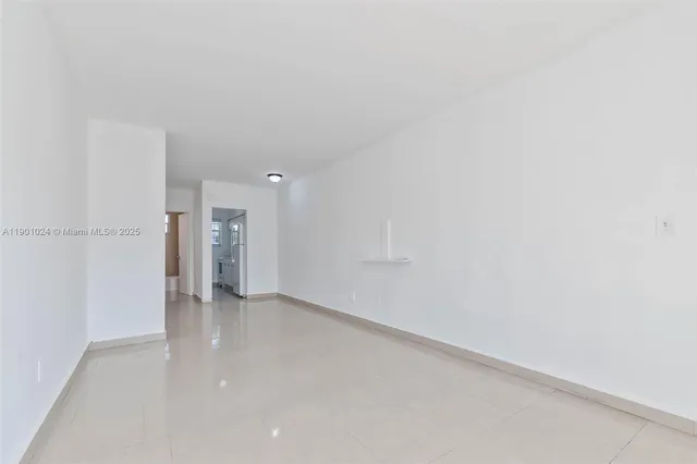 an empty room with sliding glass door