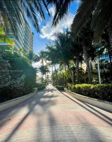a group of people sitting under an umbrella
