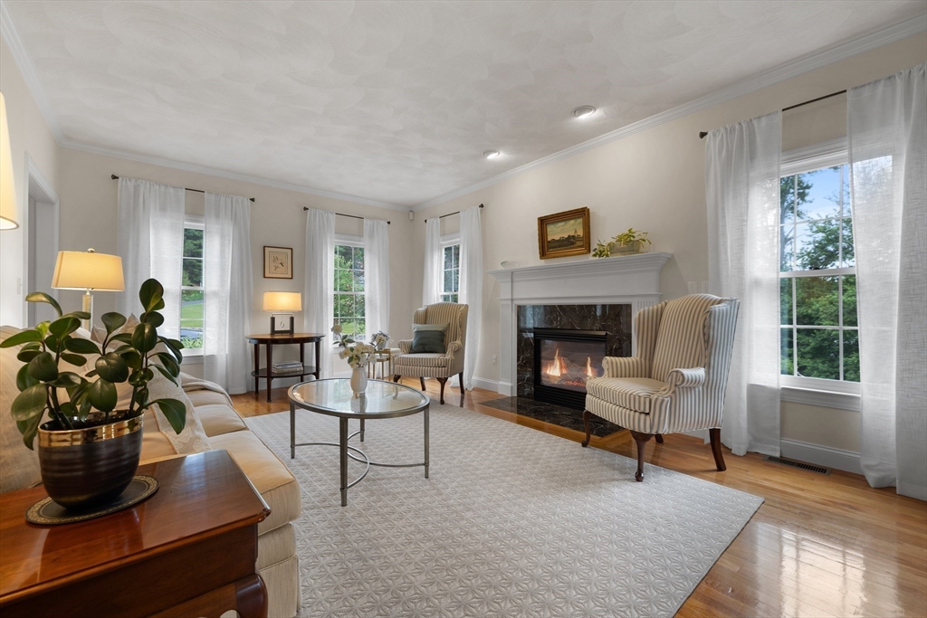 4 Coderre Way Andover, MA 01810 - Photo 7 of 35 a living room with furniture and a fireplace