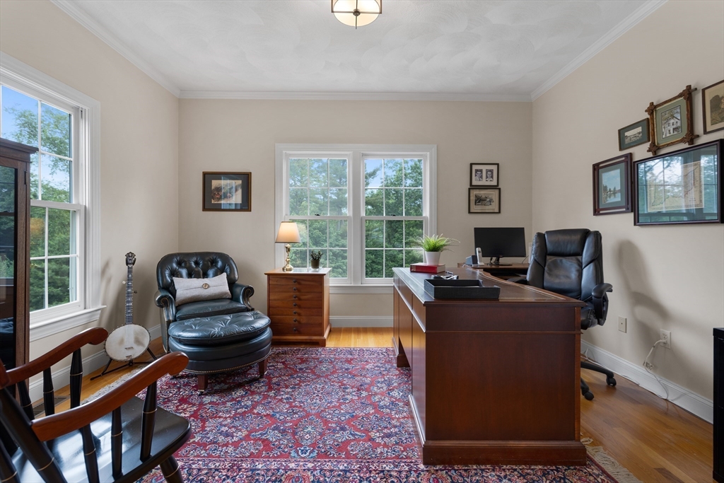 4 Coderre Way Andover, MA 01810 - Photo 8 of 35 a living room with furniture a flat screen tv and a floor to ceiling window