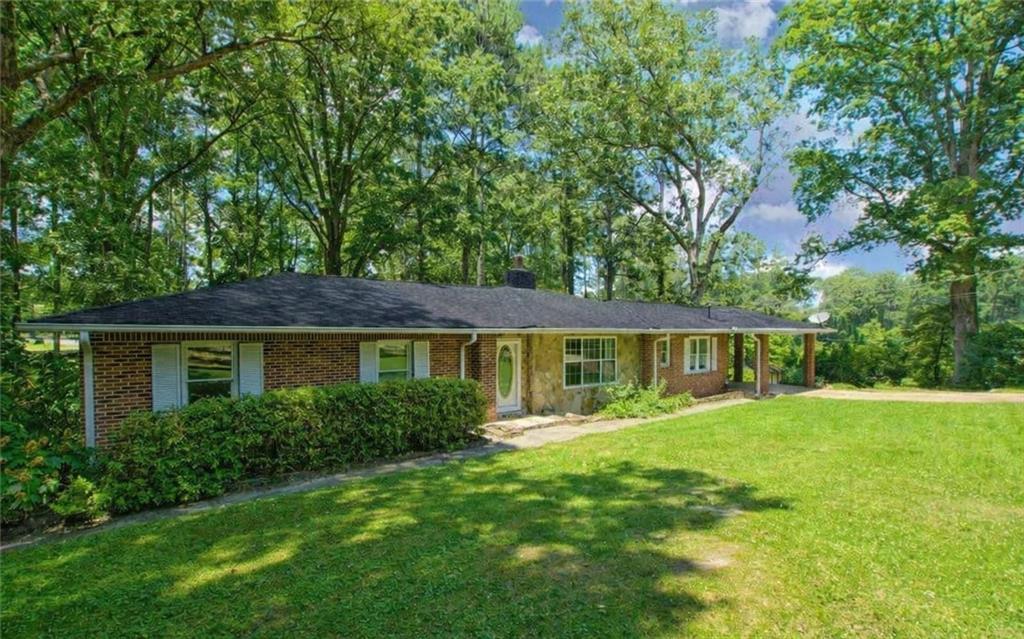 a front view of house with yard and green space