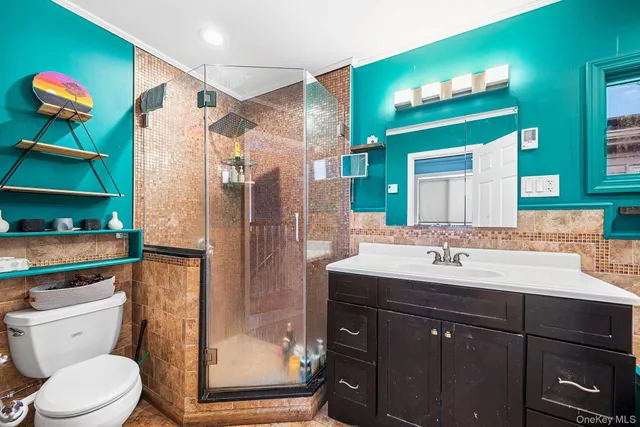 a bathroom with a sink a toilet and shower