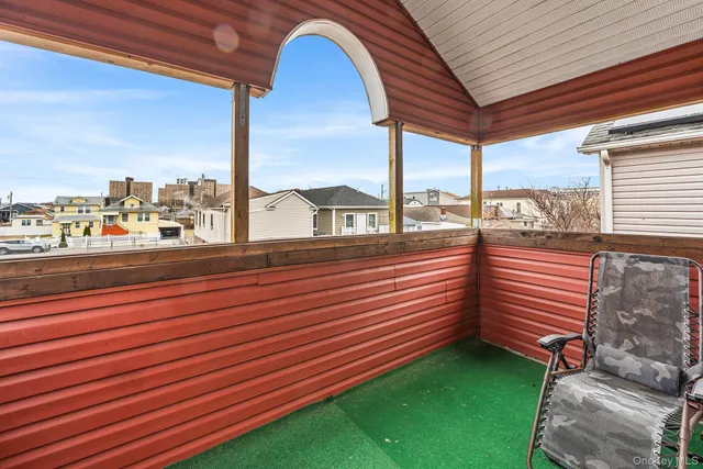 a view of a porch with furniture and garden