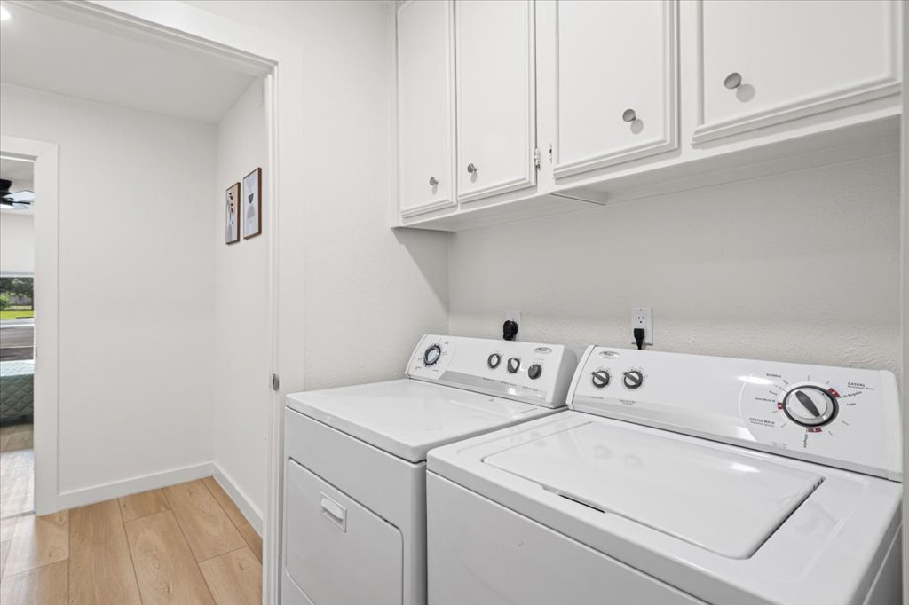 1406 North Georgetown Street Round Rock, TX 78664 - Photo 27 of 34 Functional laundry zone with overhead storage, offering ease and convenience.