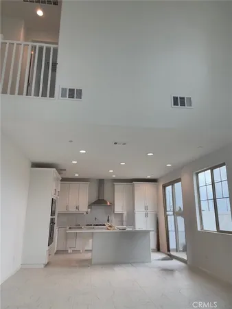 a large kitchen with a large counter top space and stainless steel appliances