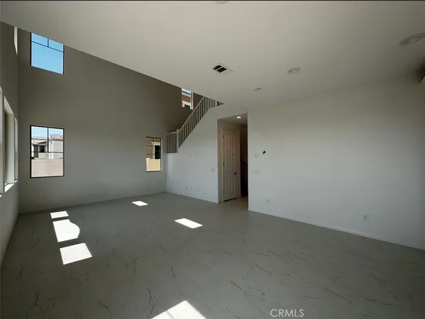 an empty room with windows and entrance