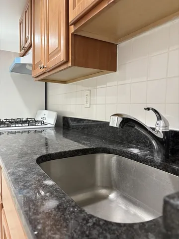 a kitchen with a stove top oven cabinets and stainless steel appliances