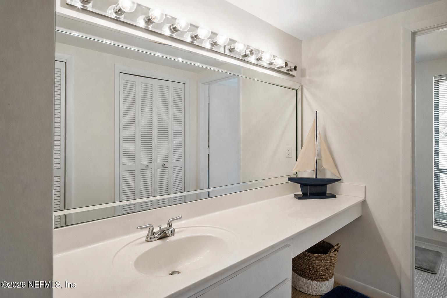 8012 Hollyridge Road, Unit 17U Jacksonville, FL 32256 - Photo 14 of 22 a bathroom with a sink and a mirror