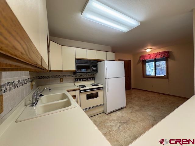 120 Camino Del Rio, Unit 35 Gunnison, CO 81230 - Photo 11 of 32 a kitchen with a refrigerator and a stove top oven