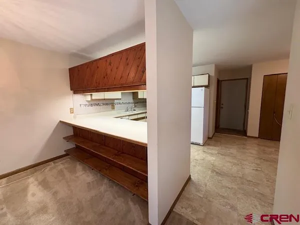a white refrigerator freezer sitting in a kitchen