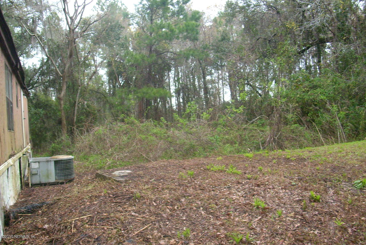 75966 Edwards Road Yulee, FL 32097 - Photo 3 of 4 a view of a yard with trees in the background