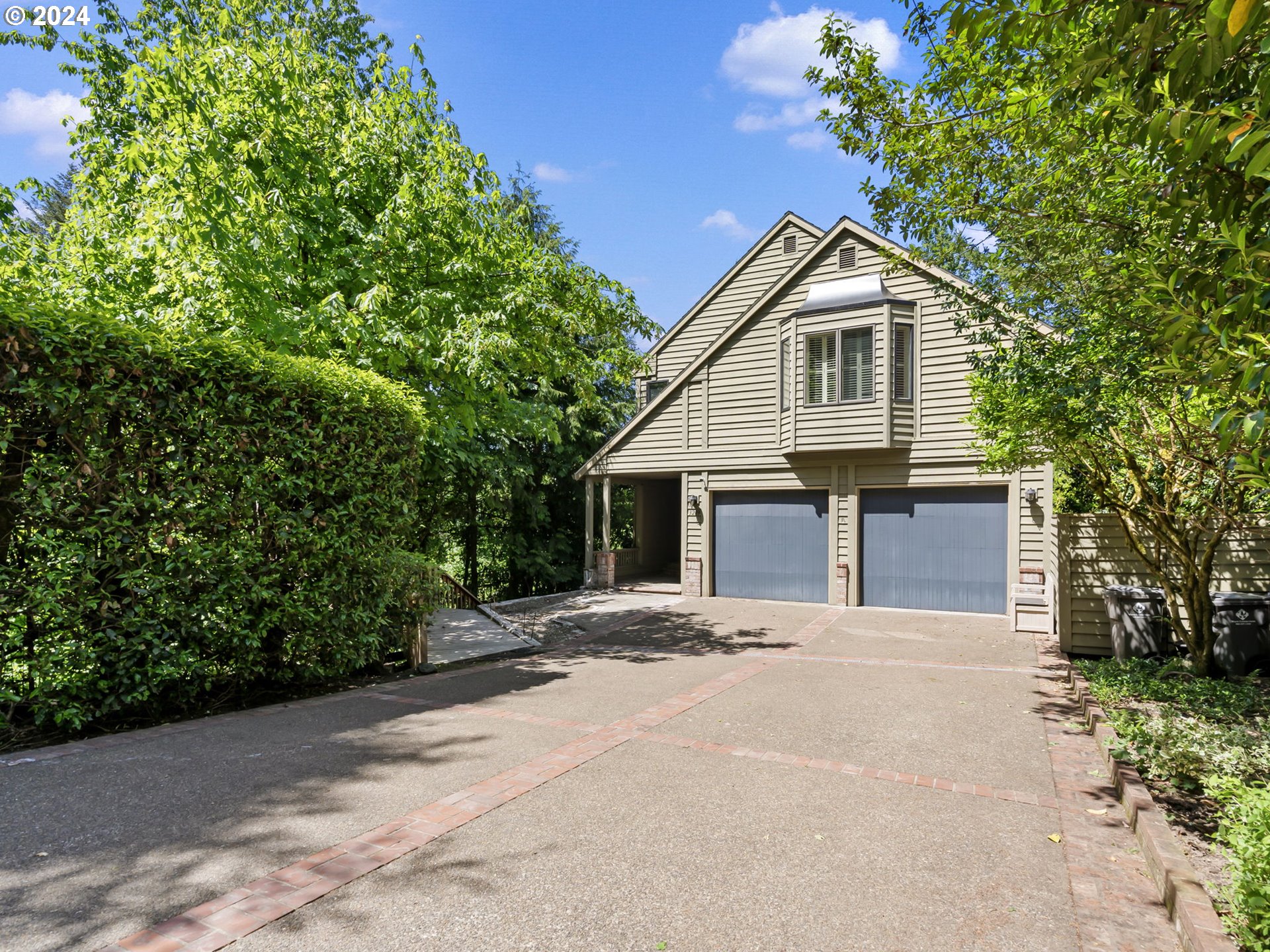 3209 Southwest Talbot Road Portland, OR 97201 - Photo 1 of 35 a front view of a house with a yard and garage