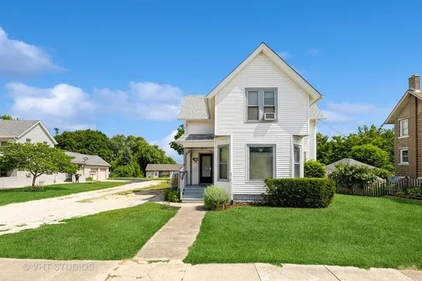 a view of house with yard and green space