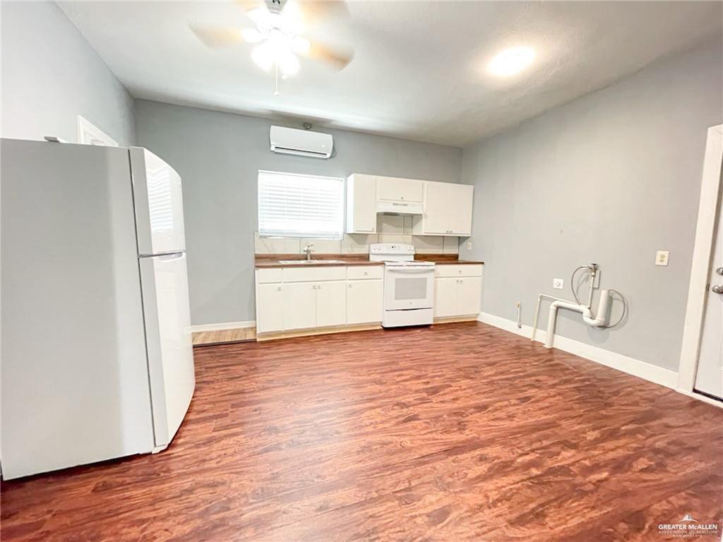 1017 East Tom Landry Street, Unit 17 Mission, TX 78572 - Photo 4 of 10 a kitchen with a refrigerator and a stove top oven
