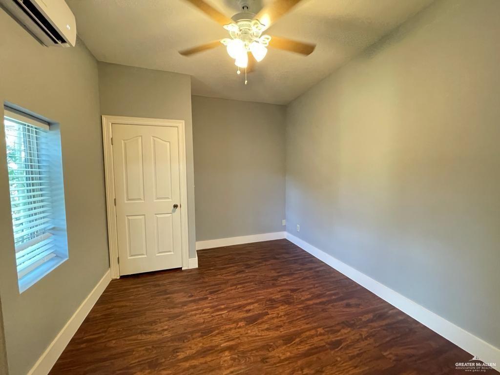 1017 East Tom Landry Street, Unit 17 Mission, TX 78572 - Photo 7 of 10 wooden floor in an empty room