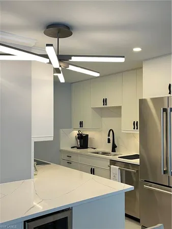 a kitchen with a refrigerator and a sink