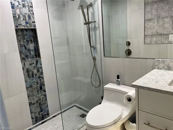 a white toilet sitting next to a bathroom sink