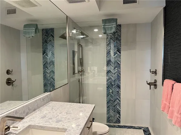 a bathroom with a shower a sink and a shower