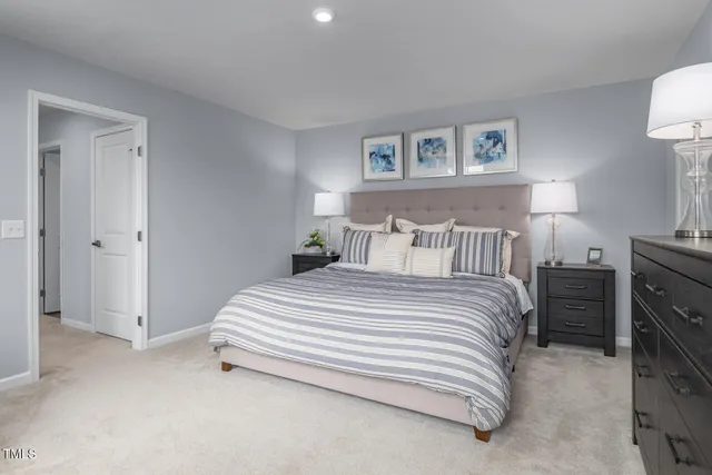 a bedroom with a large bed and a couch