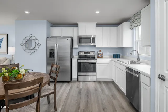 a kitchen with a sink and steel stainless steel appliances