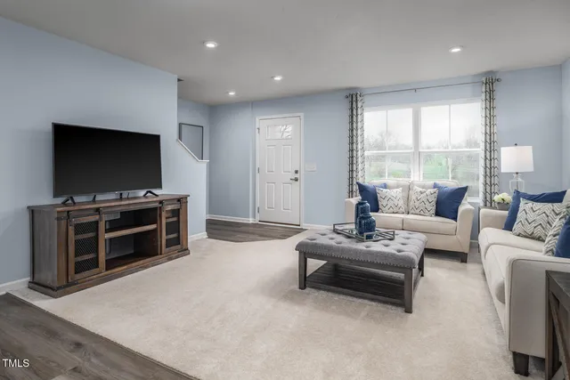 a kitchen with granite countertop a refrigerator stove and microwave