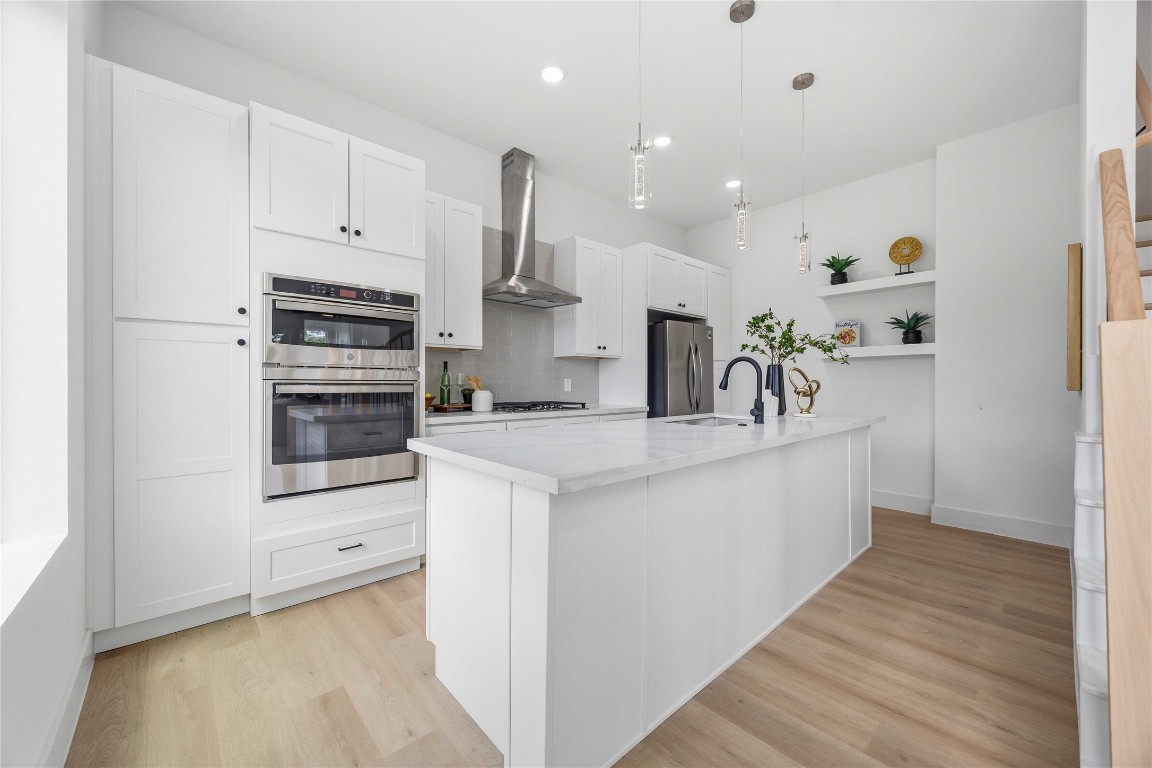 3103 Lelia Street, Unit B Houston, TX 77026 - Photo 11 of 30 a kitchen with stainless steel appliances kitchen island granite countertop a refrigerator and a sink