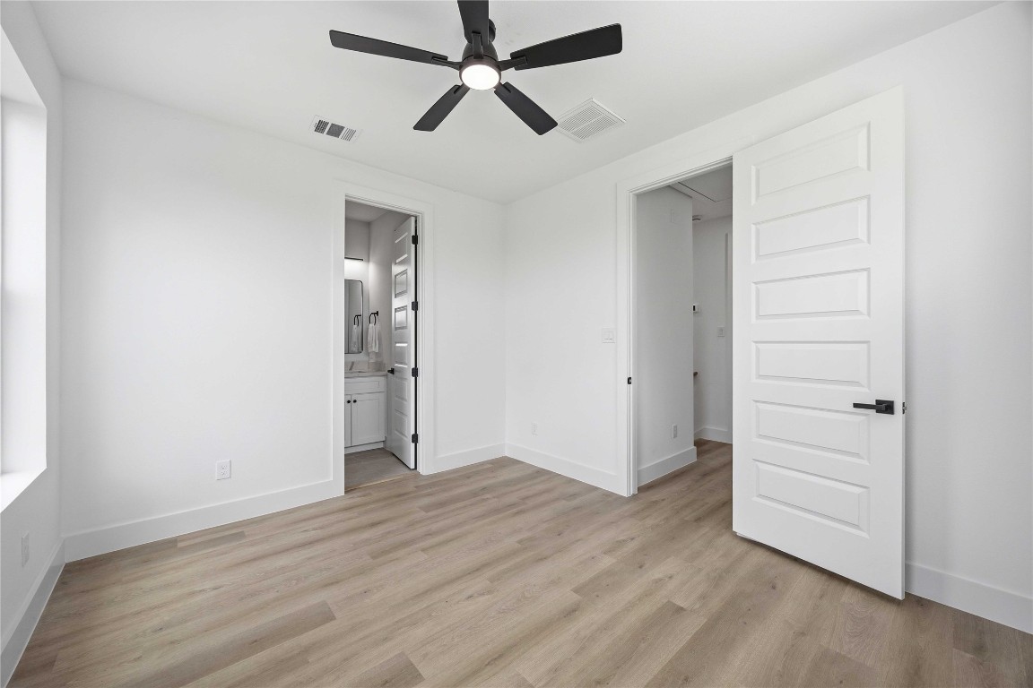 3103 Lelia Street, Unit B Houston, TX 77026 - Photo 19 of 30 an empty room with wooden floor a ceiling fan and windows
