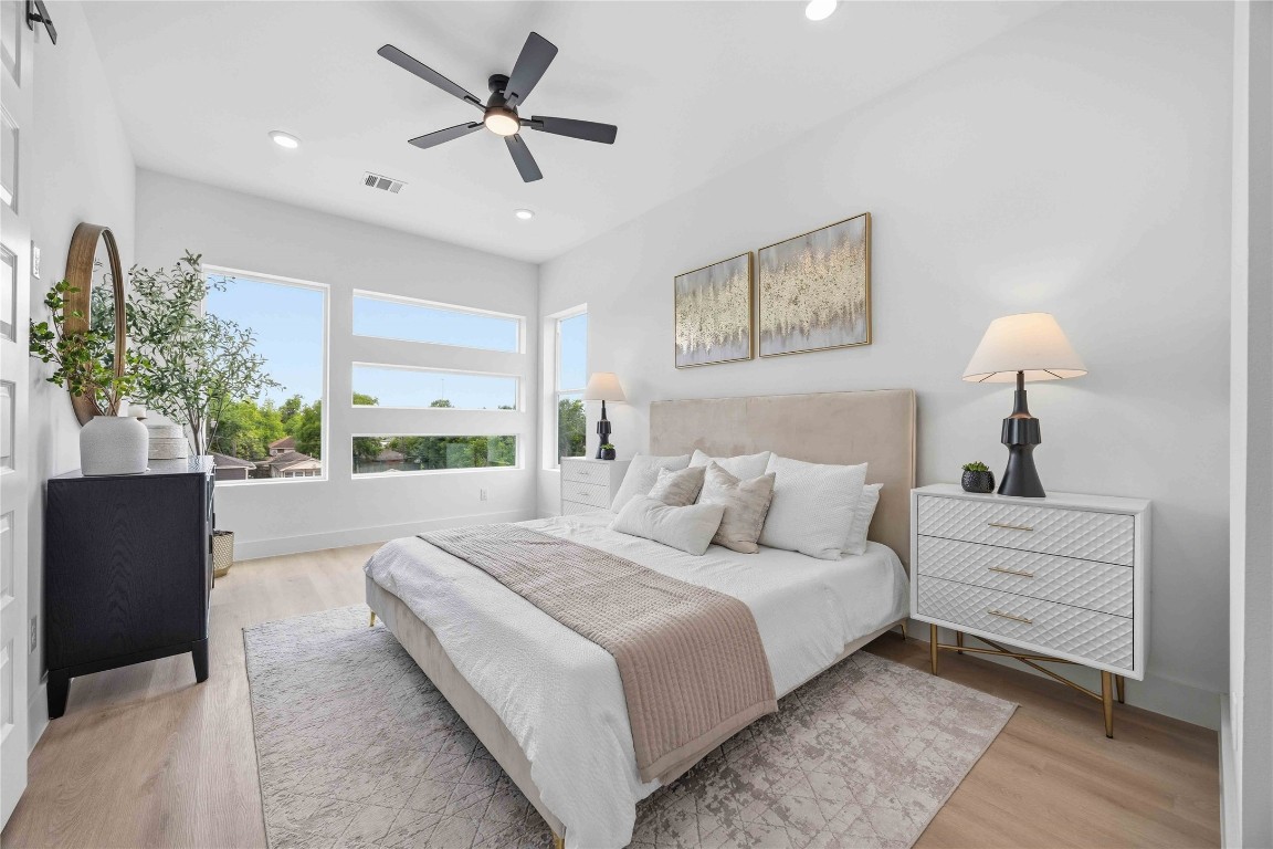 3103 Lelia Street, Unit B Houston, TX 77026 - Photo 22 of 30 a bedroom with a large bed and a chandelier
