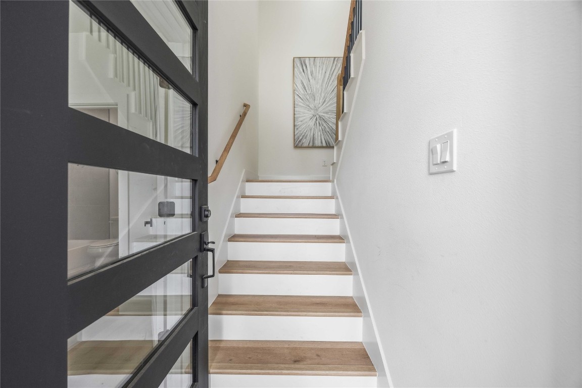 3103 Lelia Street, Unit B Houston, TX 77026 - Photo 5 of 30 a view of staircase with white walls and a black wall painting on the wall