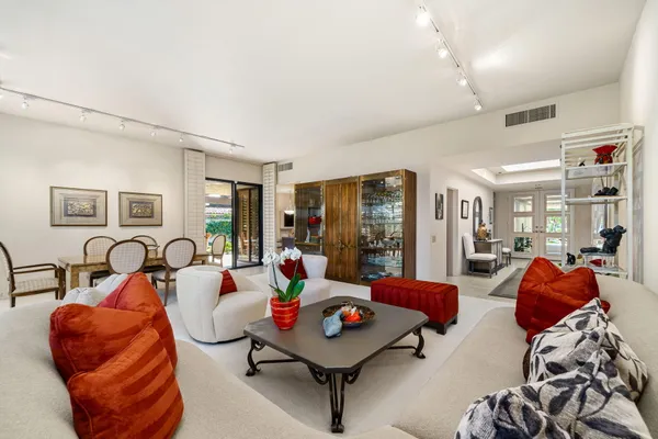 a kitchen with kitchen island granite countertop a table and chairs in it