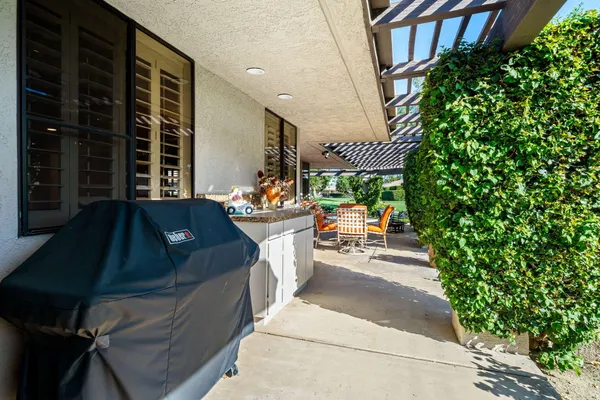 a view of a patio with table and chairs and potted plants