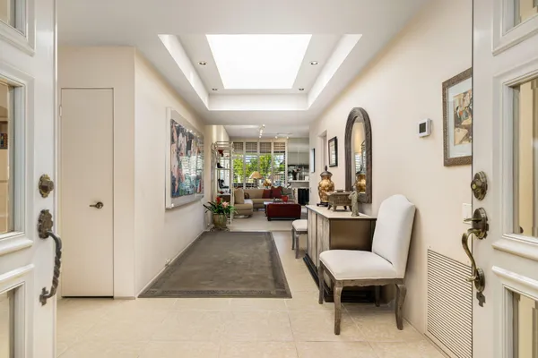 a living room with furniture kitchen view and large windows