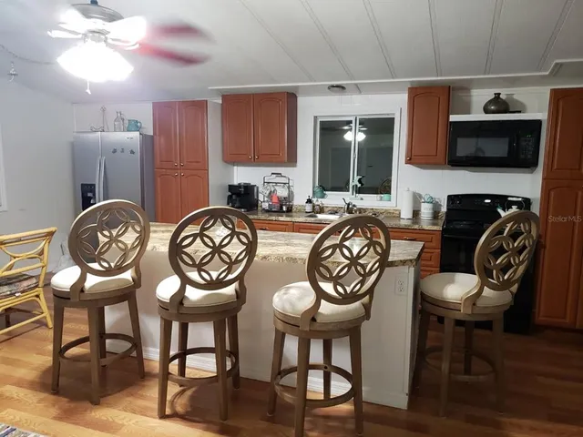 a view of a kitchen with granite countertop a table and chairs