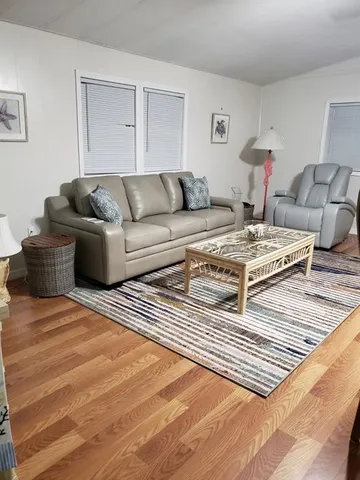 a living room with furniture and a rug