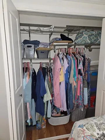 a view of walk in closet with clothes