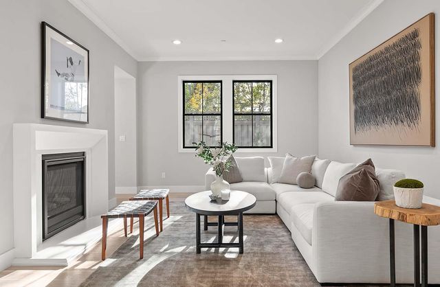 a living room with furniture a table and a fireplace