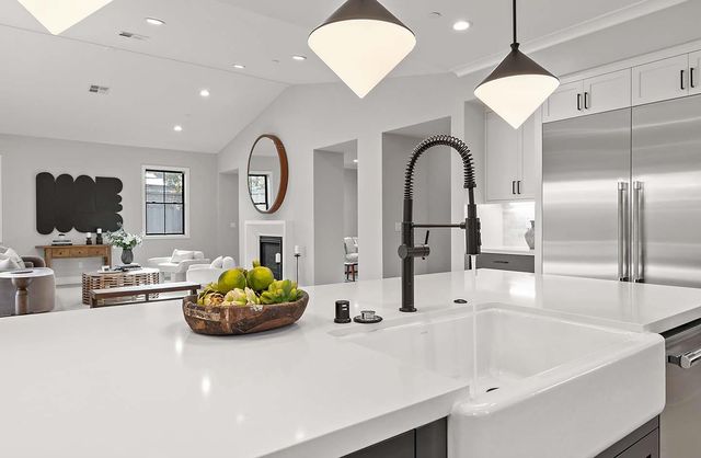 a living room with furniture chandelier and a flat screen tv