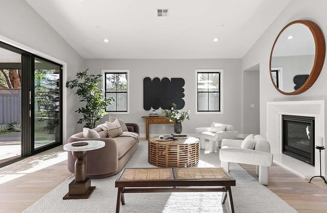 a living room with furniture a fireplace and a flat screen tv