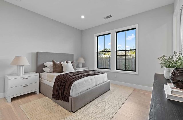 a spacious bedroom with a large bed and a window