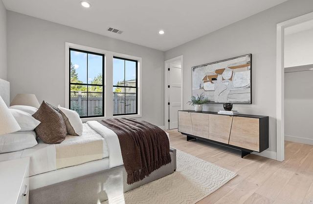 a bedroom with a bed and a painting on the wall