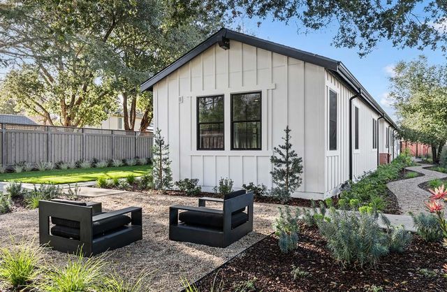 a view of a backyard with sitting area