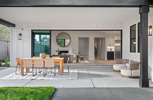 a living room with furniture a large window and a clock
