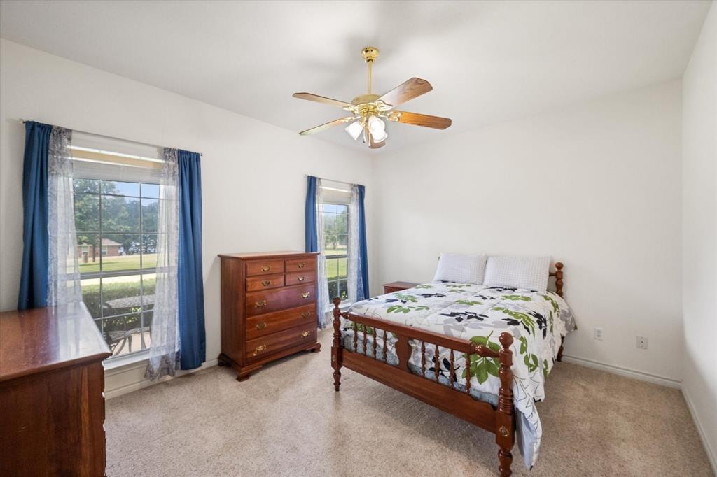 13021 Rudy's Way Streetman, TX 75859 - Photo 20 of 40 Secondary bedroom near Richland Chambers Lake with two windows, neutral finishes, and space for guests, hobbies, or office use.