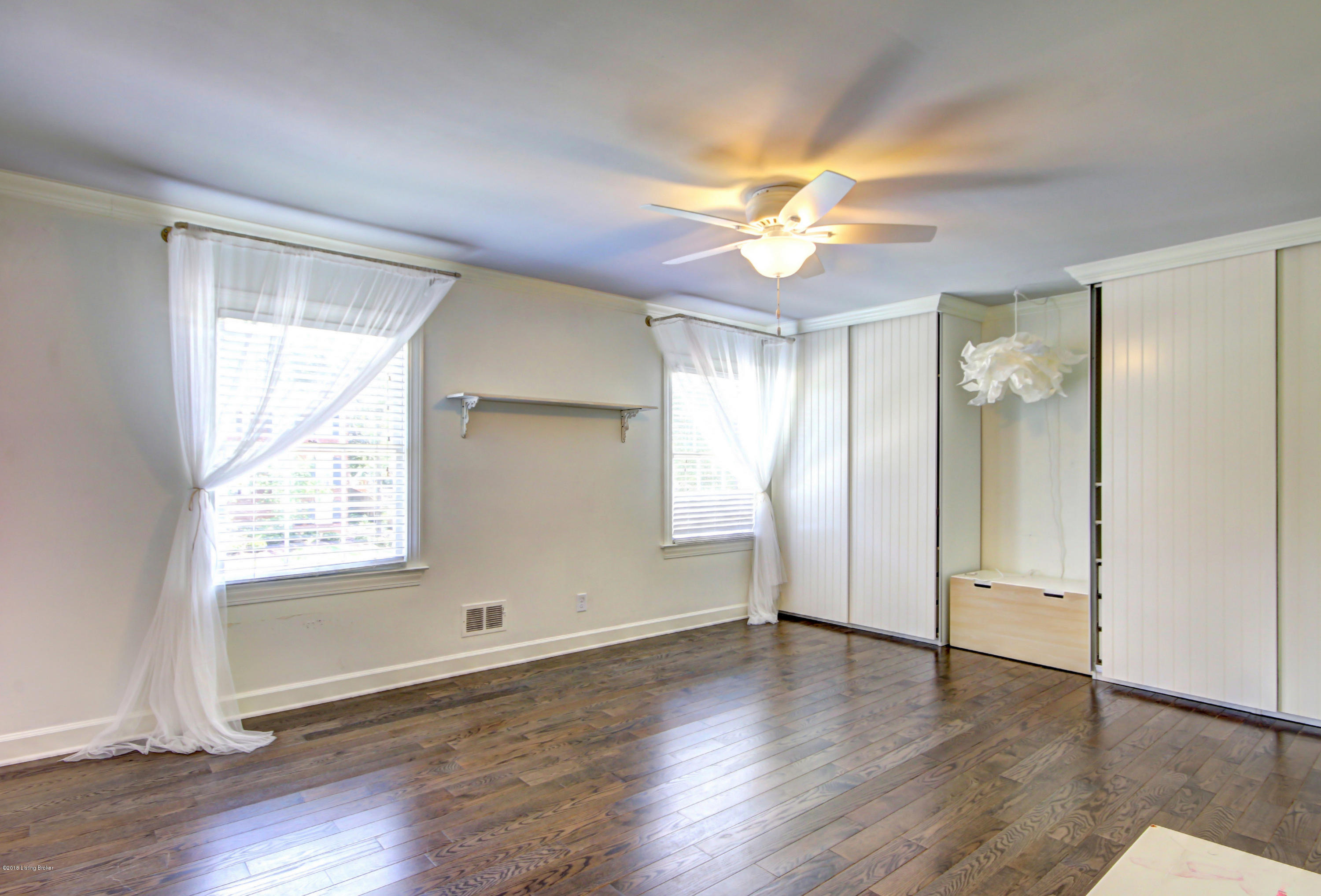 5505 Apache Road Louisville, KY 40207 - Photo 35 of 62 Spacious bedroom featuring oak floors and custom closets