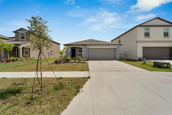 a front view of a house with a yard and garage