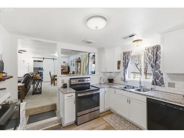 a kitchen with a sink stove and cabinets