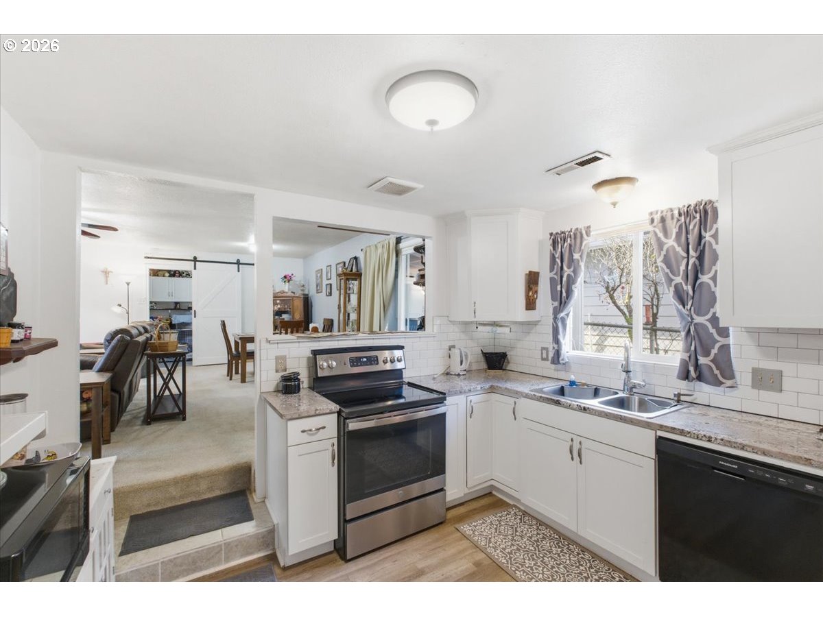 2295 Cedar Street Sweet Home, OR 97386 - Photo 11 of 32 a kitchen with a sink stove and cabinets