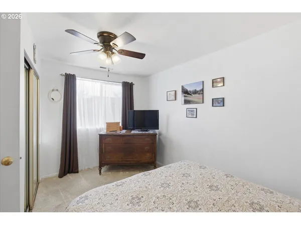 a living room with furniture and a ceiling fan