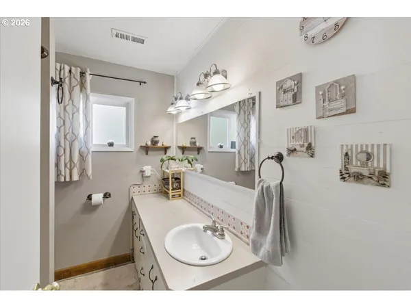 a bathroom with a sink mirror and vanity