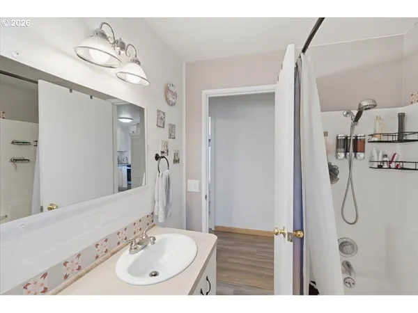 a bathroom with a sink a mirror and shower